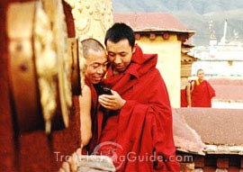 Lamas playing with mobile phone, Jokhang Temple